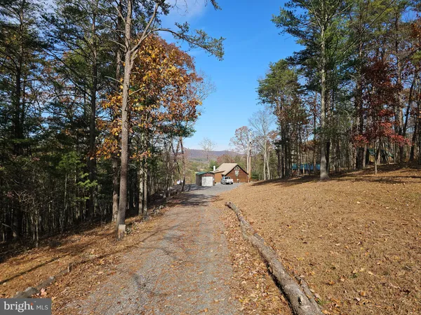 a view of a wooden fence and trees