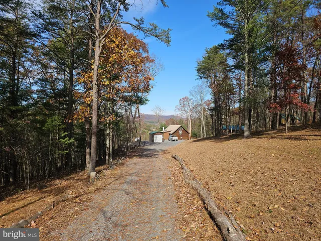 a view of a wooden fence and trees