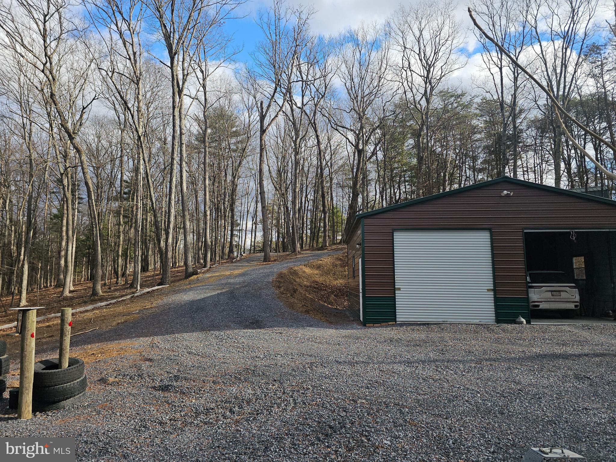211 Martin Road Artemas, PA 17211 - Photo 34 of 38 a view of a house with a yard and garage