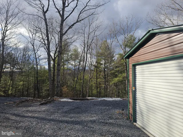 a view of a dry yard with wooden fence