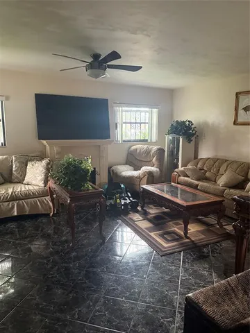 a living room with furniture a rug and a window