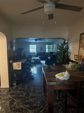a dining room with furniture and window