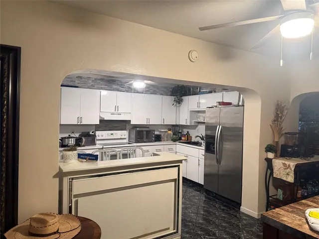 a kitchen with a refrigerator sink and stove