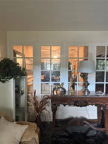 a living room with furniture and a floor to ceiling window