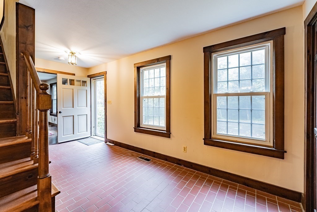 22 Upper Pomeroy Road Montgomery, MA 01085 - Photo 3 of 23 a view of an empty room with a window and wooden floor