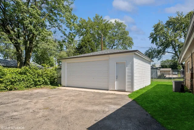a view of a house with a yard and garage