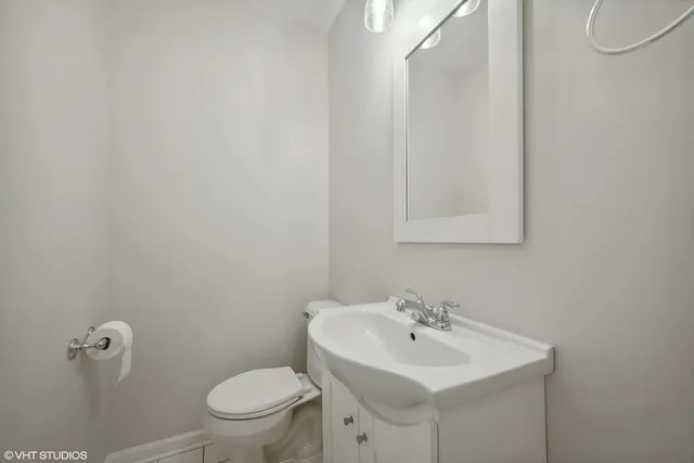 a bathroom with a sink a toilet and mirror