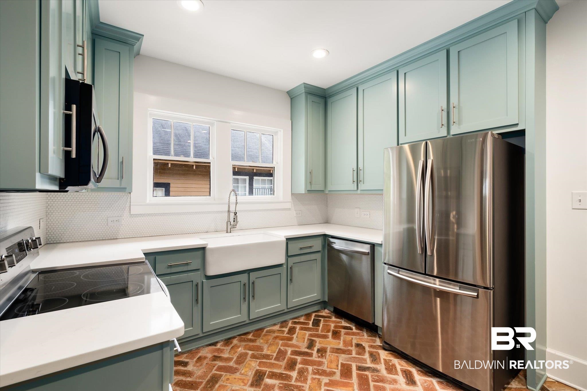 308 South Ann Street Mobile, AL 36604 - Photo 9 of 30 Kitchen with green cabinets, stainless steel appliances, decorative backsplash, and sink