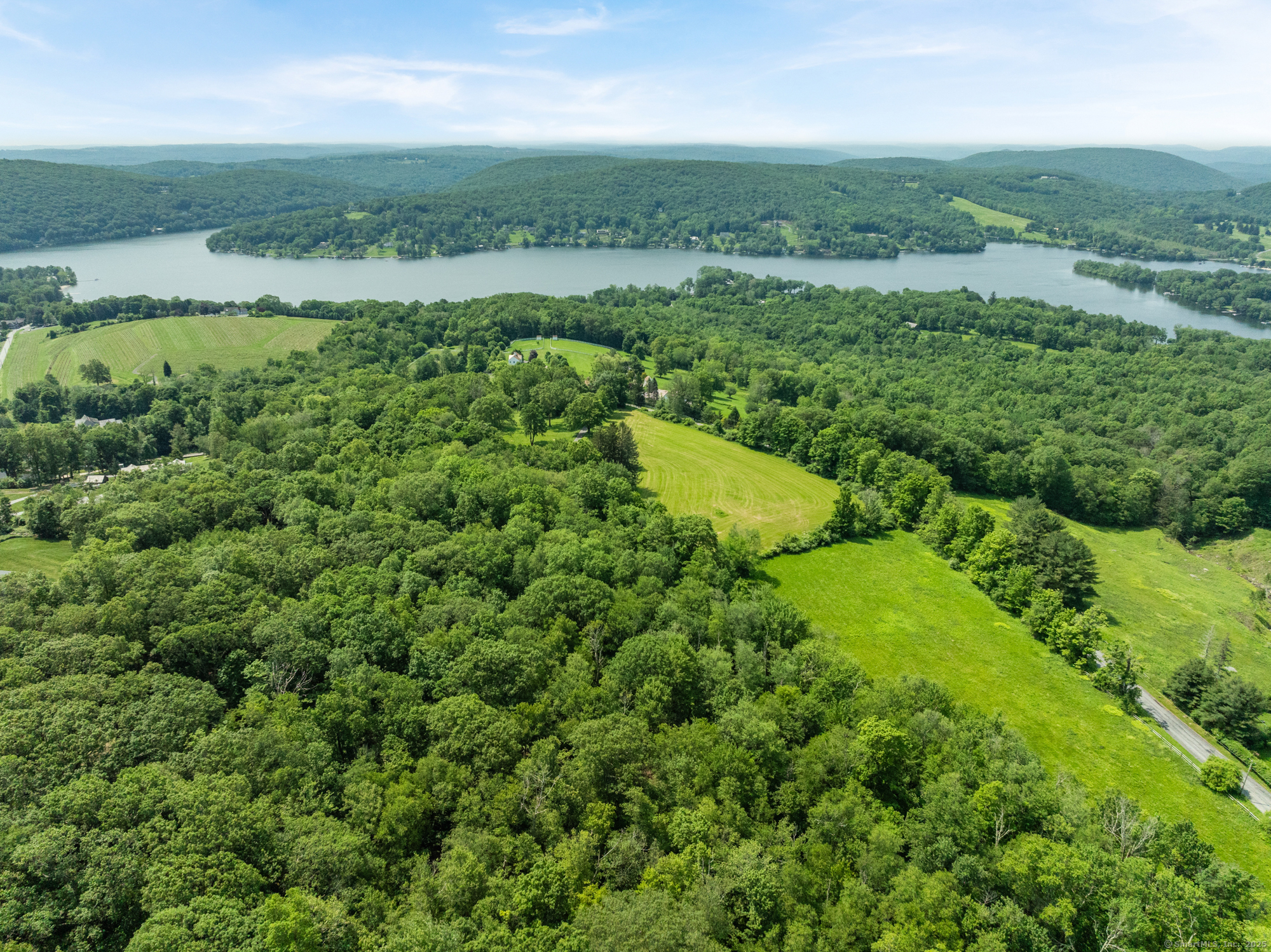 Curtiss Road Warren, CT 06777 - Photo 8 of 13 an aerial view of green landscape with trees houses and mountain view