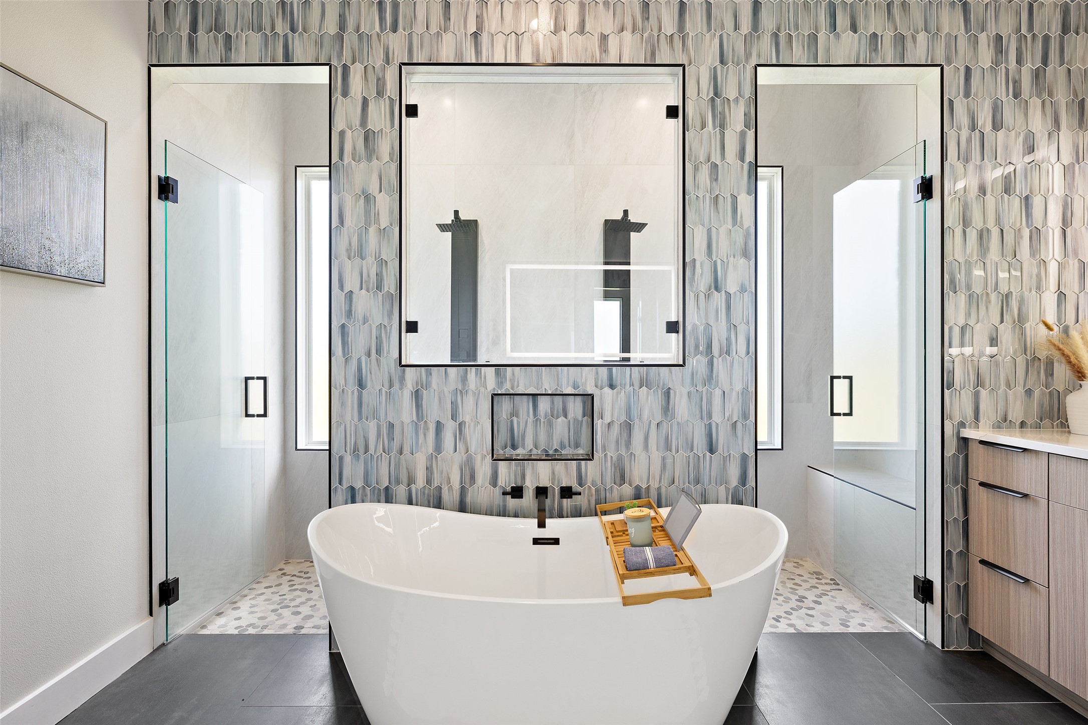 117 Hannahs Way Burnet, TX 78611 - Photo 19 of 28 a bathroom with a white bath tub a mirror and a shower