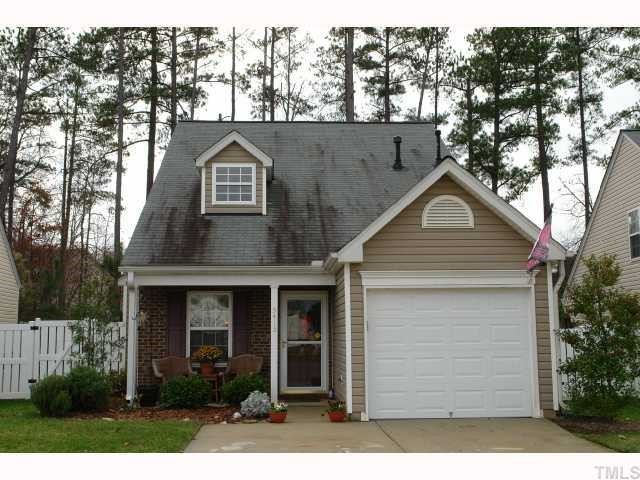 5413 Golden Moss Trail Raleigh, NC 27613 - Photo 1 of 12 a front view of a house with a yard and garage