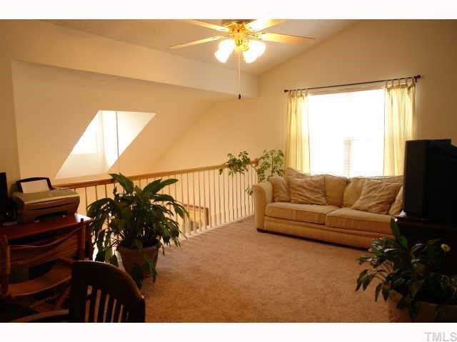 5413 Golden Moss Trail Raleigh, NC 27613 - Photo 11 of 12 a living room with furniture and a flat screen tv