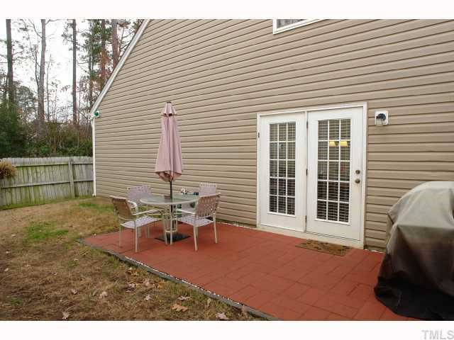 5413 Golden Moss Trail Raleigh, NC 27613 - Photo 12 of 12 a backyard of a house with table and chairs
