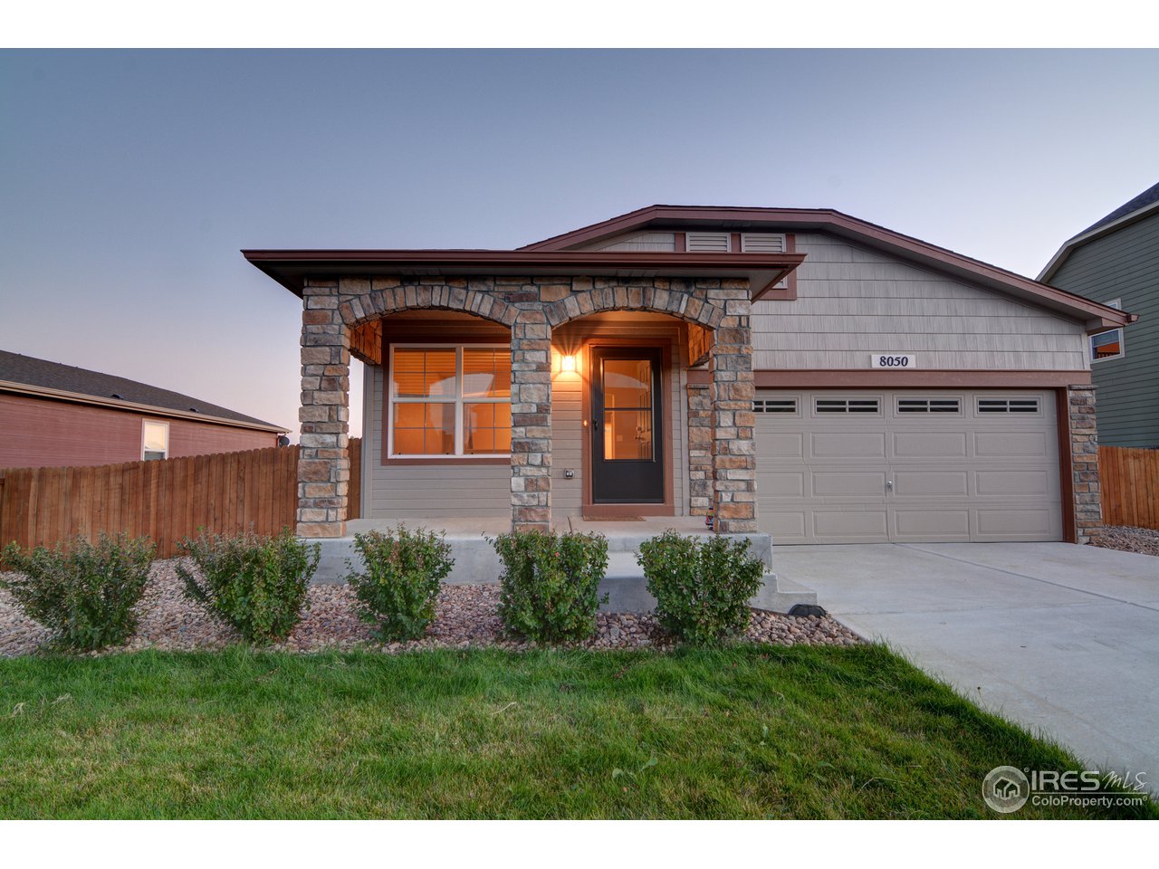 8050 Raspberry Drive Frederick, CO 80504 - Photo 1 of 17 a front view of a house with garden