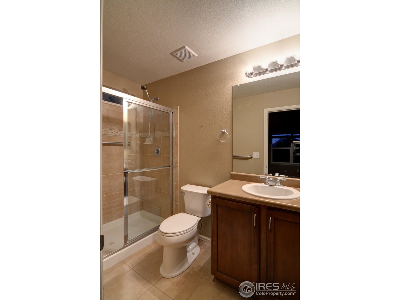 8050 Raspberry Drive Frederick, CO 80504 - Photo 12 of 17 a bathroom with a toilet sink and mirror