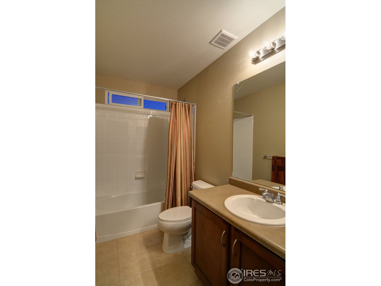8050 Raspberry Drive Frederick, CO 80504 - Photo 14 of 17 a bathroom with a sink toilet and shower
