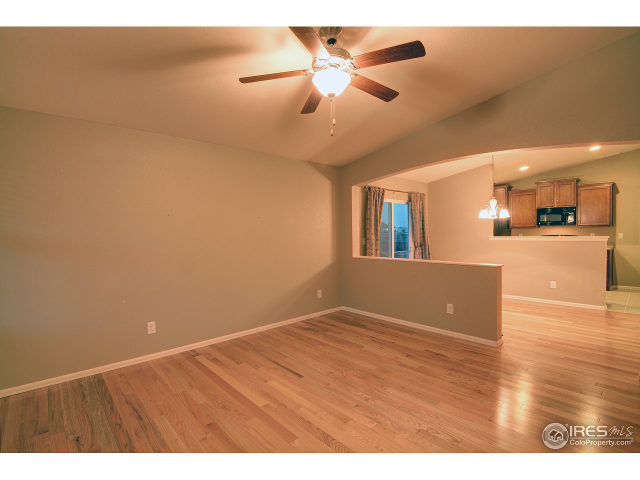 8050 Raspberry Drive Frederick, CO 80504 - Photo 2 of 17 a view of a livingroom with a ceiling fan and wooden floor