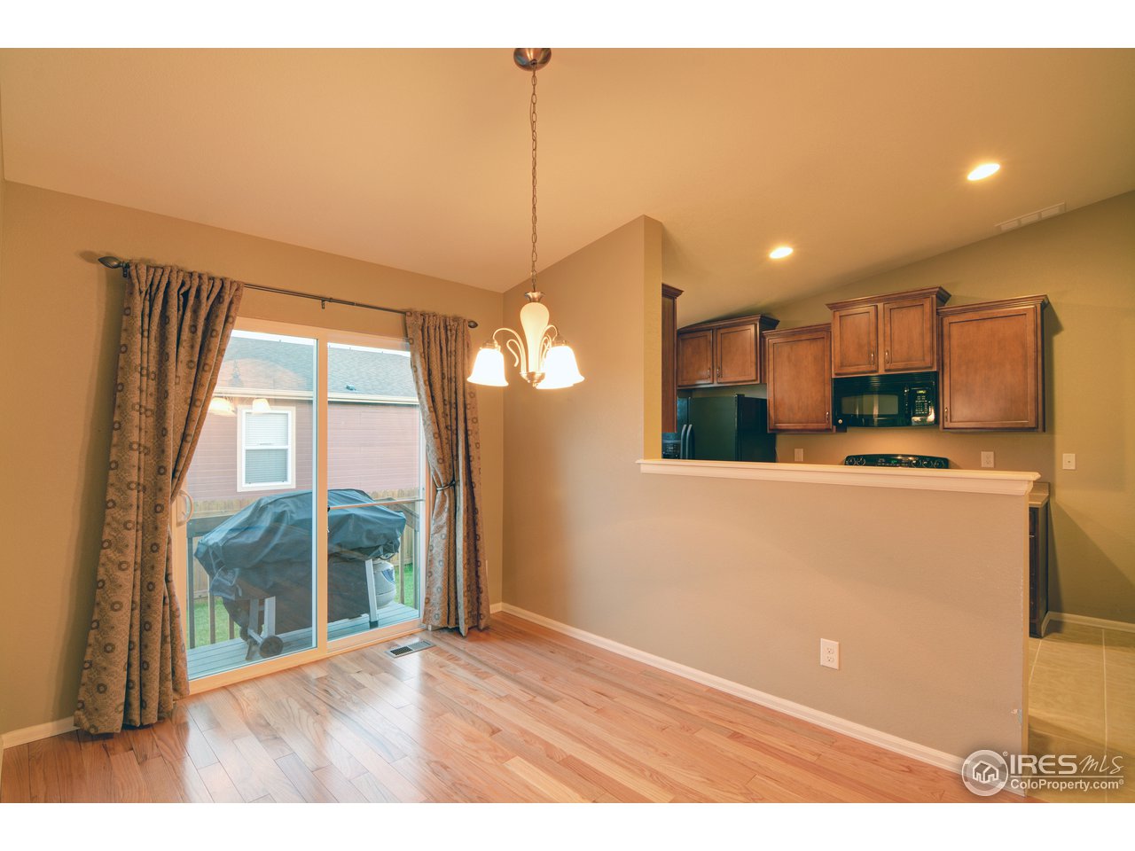 8050 Raspberry Drive Frederick, CO 80504 - Photo 3 of 17 a view of a kitchen with furniture and a floor to ceiling window