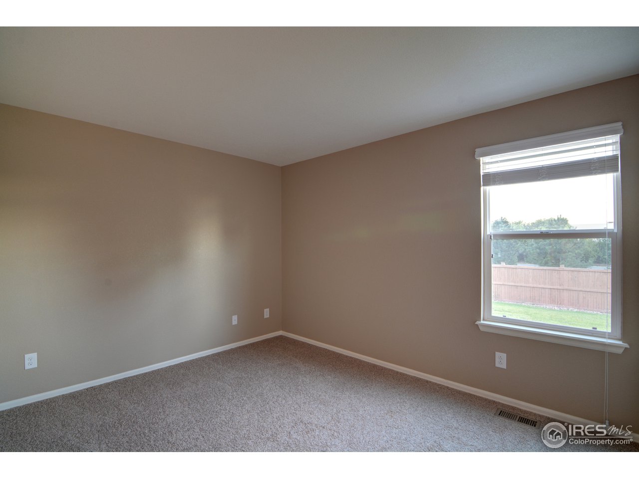 8050 Raspberry Drive Frederick, CO 80504 - Photo 10 of 17 a view of an empty room with a window