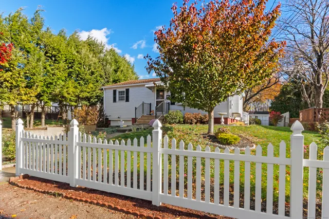 a view of a house with wooden fence