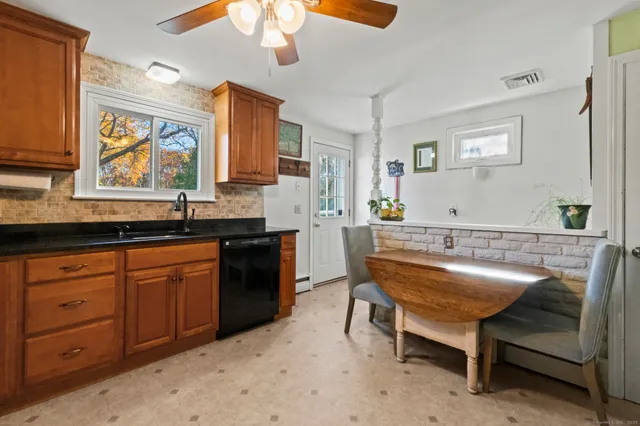 a kitchen with a sink cabinets and window