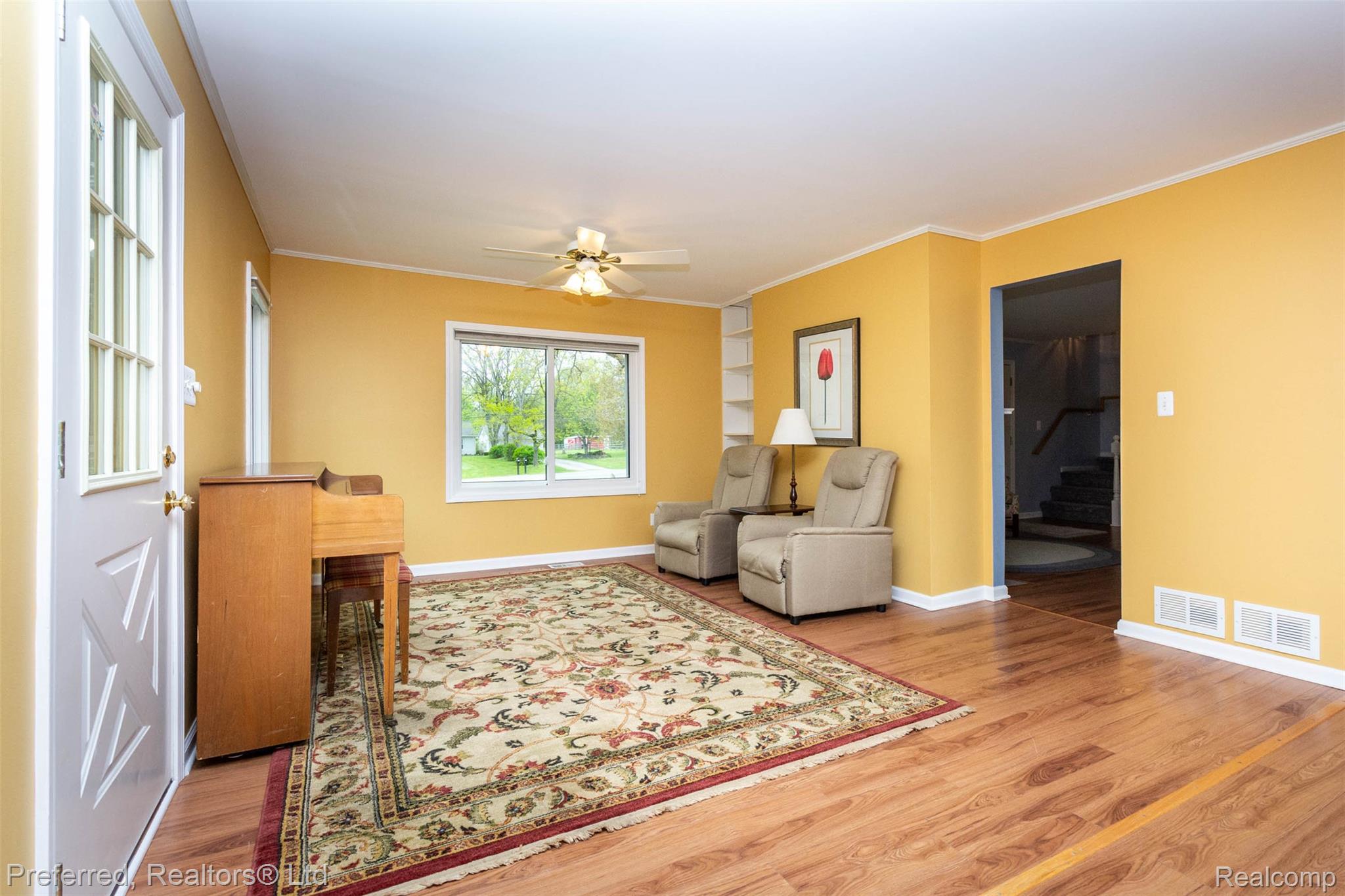 9840 Currie Road Northville, MI 48167 - Photo 11 of 62 Sitting room featuring ceiling fan, light wood-style floors, and ornamental molding