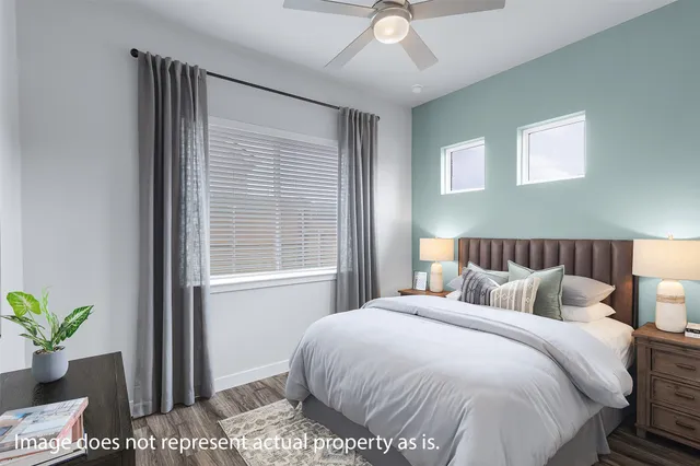 a bedroom with a bed and a window