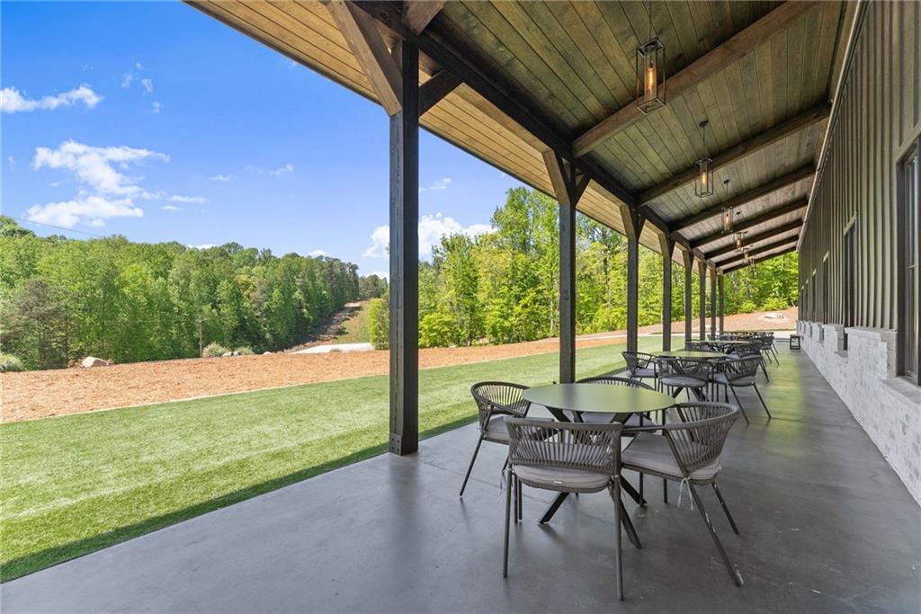 3263 Tanners Mill Road Gainesville, GA 30507 - Photo 107 of 197 a view of an outdoor dining space with a table and chairs