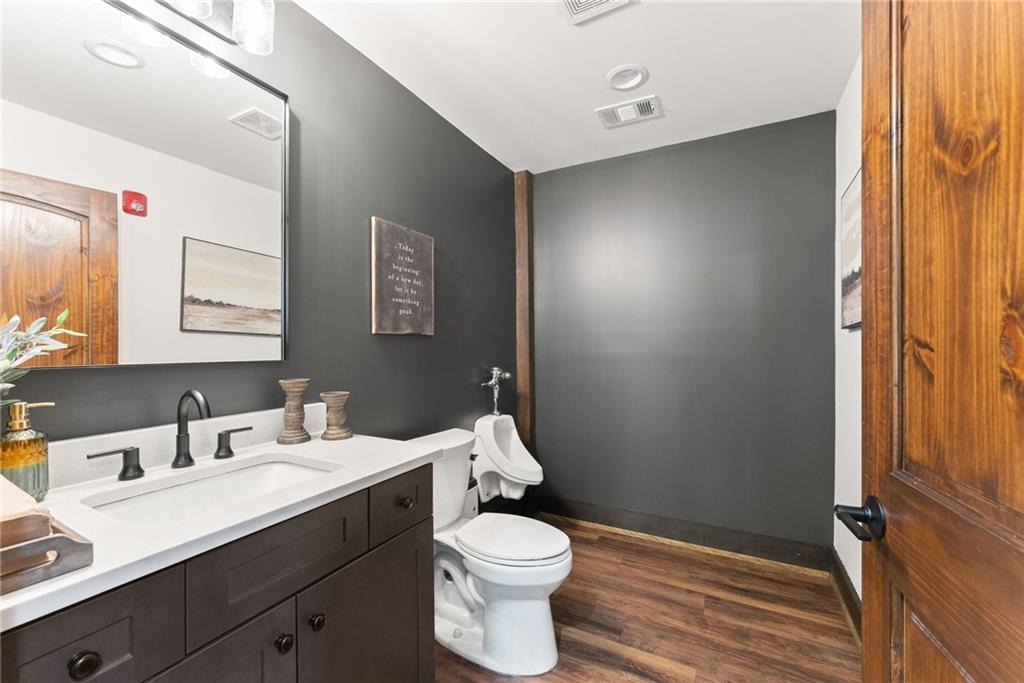 3263 Tanners Mill Road Gainesville, GA 30507 - Photo 127 of 197 a bathroom with a sink vanity mirror and toilet