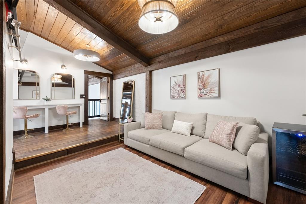 3263 Tanners Mill Road Gainesville, GA 30507 - Photo 131 of 197 a living room with furniture and a chandelier