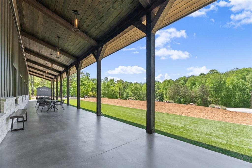 3263 Tanners Mill Road Gainesville, GA 30507 - Photo 144 of 197 a view of a porch with furniture and garden