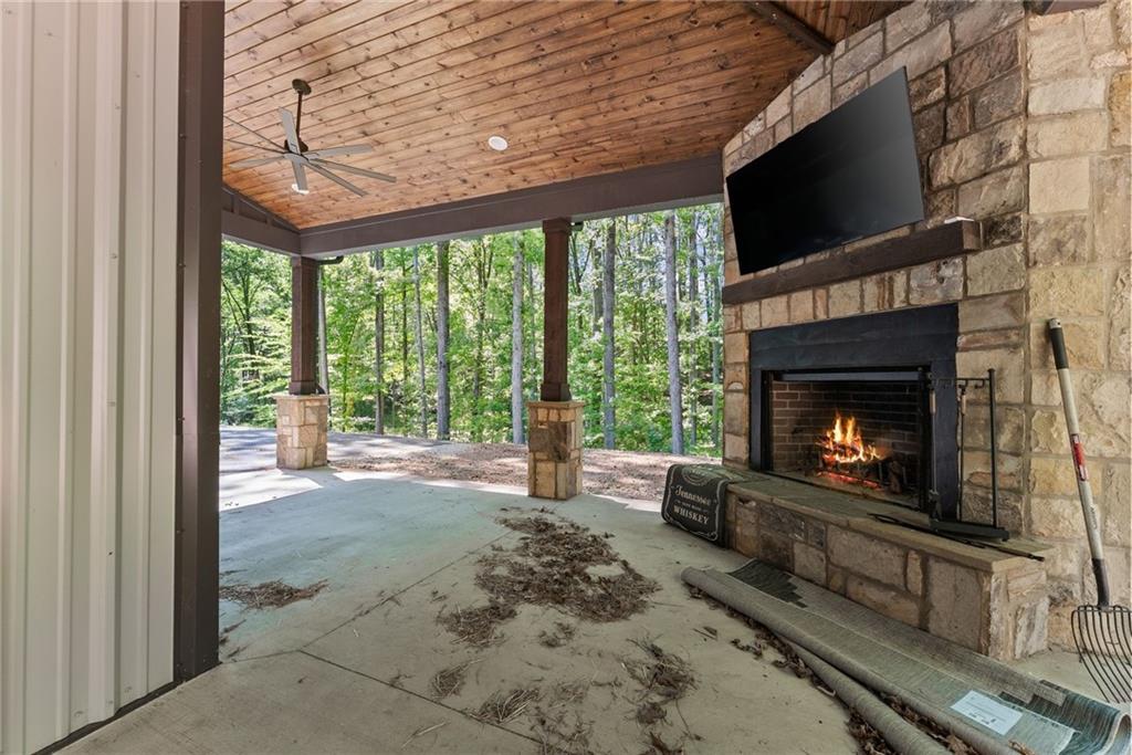 3263 Tanners Mill Road Gainesville, GA 30507 - Photo 148 of 197 a living room with furniture a fireplace and a flat screen tv