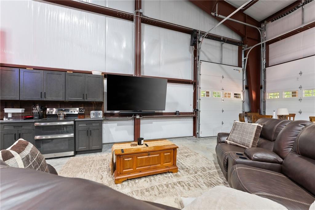 3263 Tanners Mill Road Gainesville, GA 30507 - Photo 159 of 197 a living room with furniture and a flat screen tv