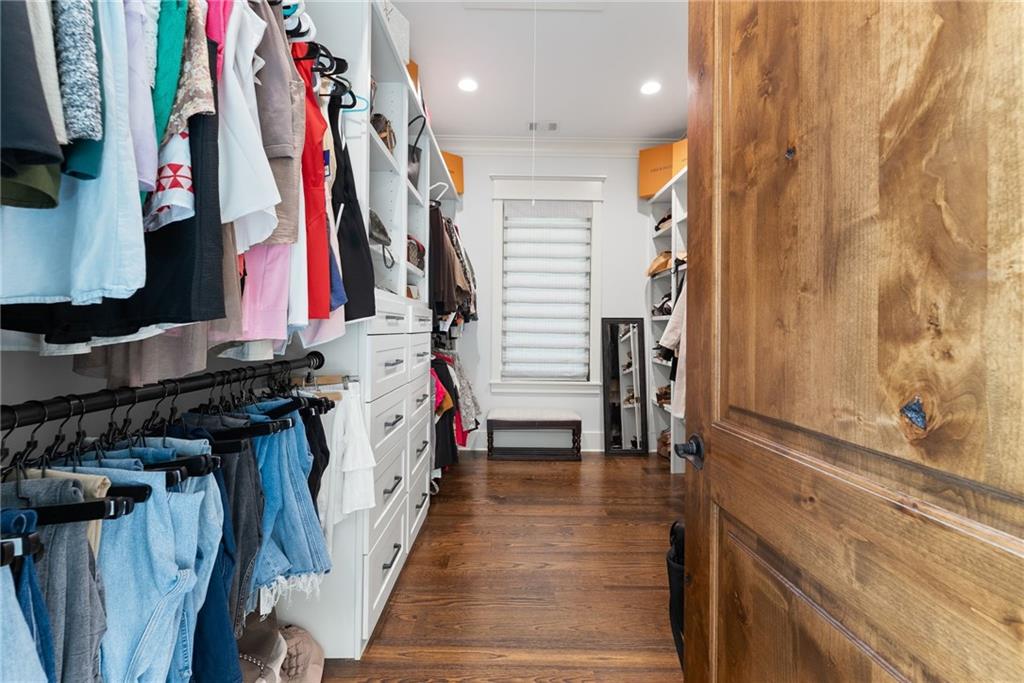 3263 Tanners Mill Road Gainesville, GA 30507 - Photo 64 of 197 a view of walk in closet with clothes and shoes