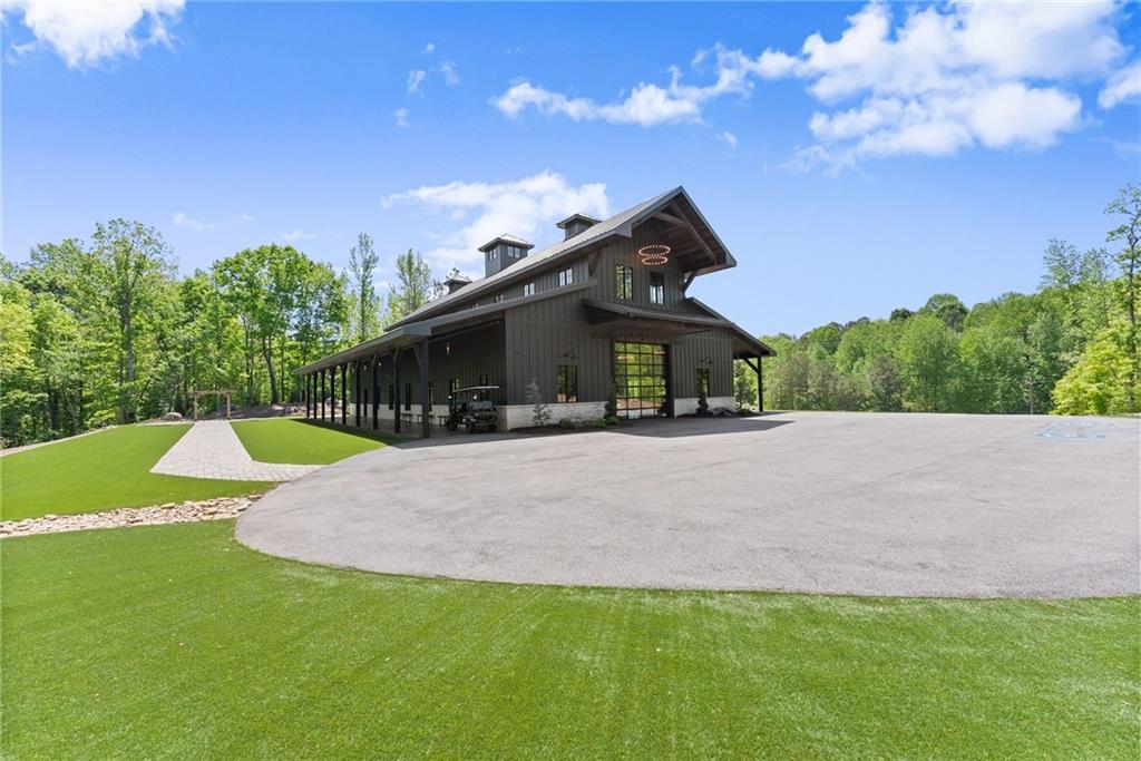 3263 Tanners Mill Road Gainesville, GA 30507 - Photo 96 of 197 a view of a house with a yard and sitting area