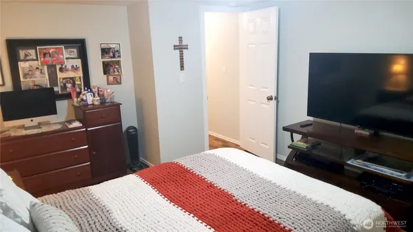 a bedroom with a bed and a flat screen tv