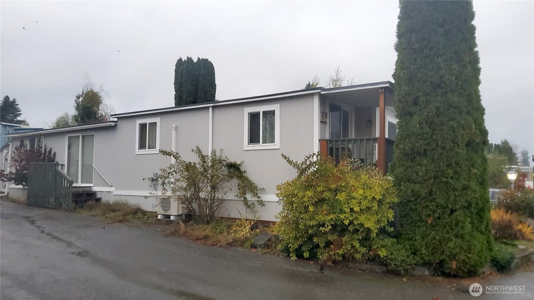 13320 Highway 99, Unit 34 Everett, WA 98204 - Photo 20 of 23 a house that has a tree in front of it