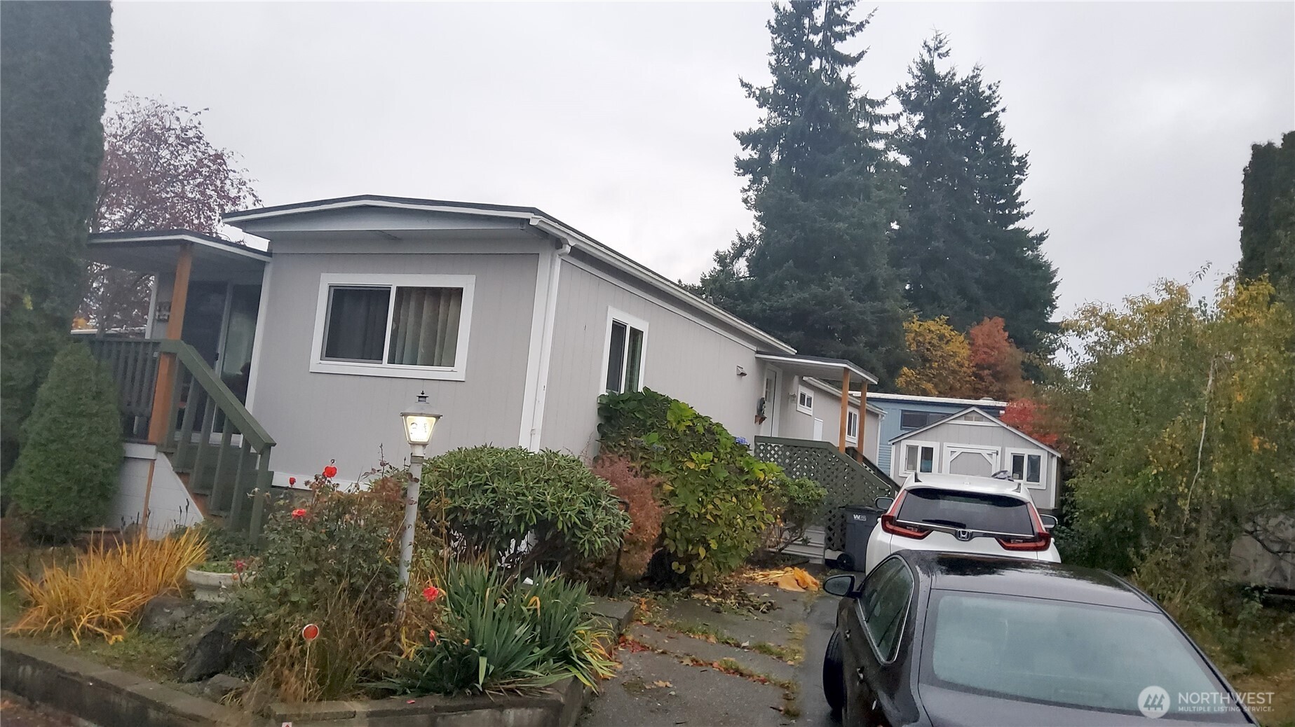 13320 Highway 99, Unit 34 Everett, WA 98204 - Photo 2 of 23 a front view of a house with a yard