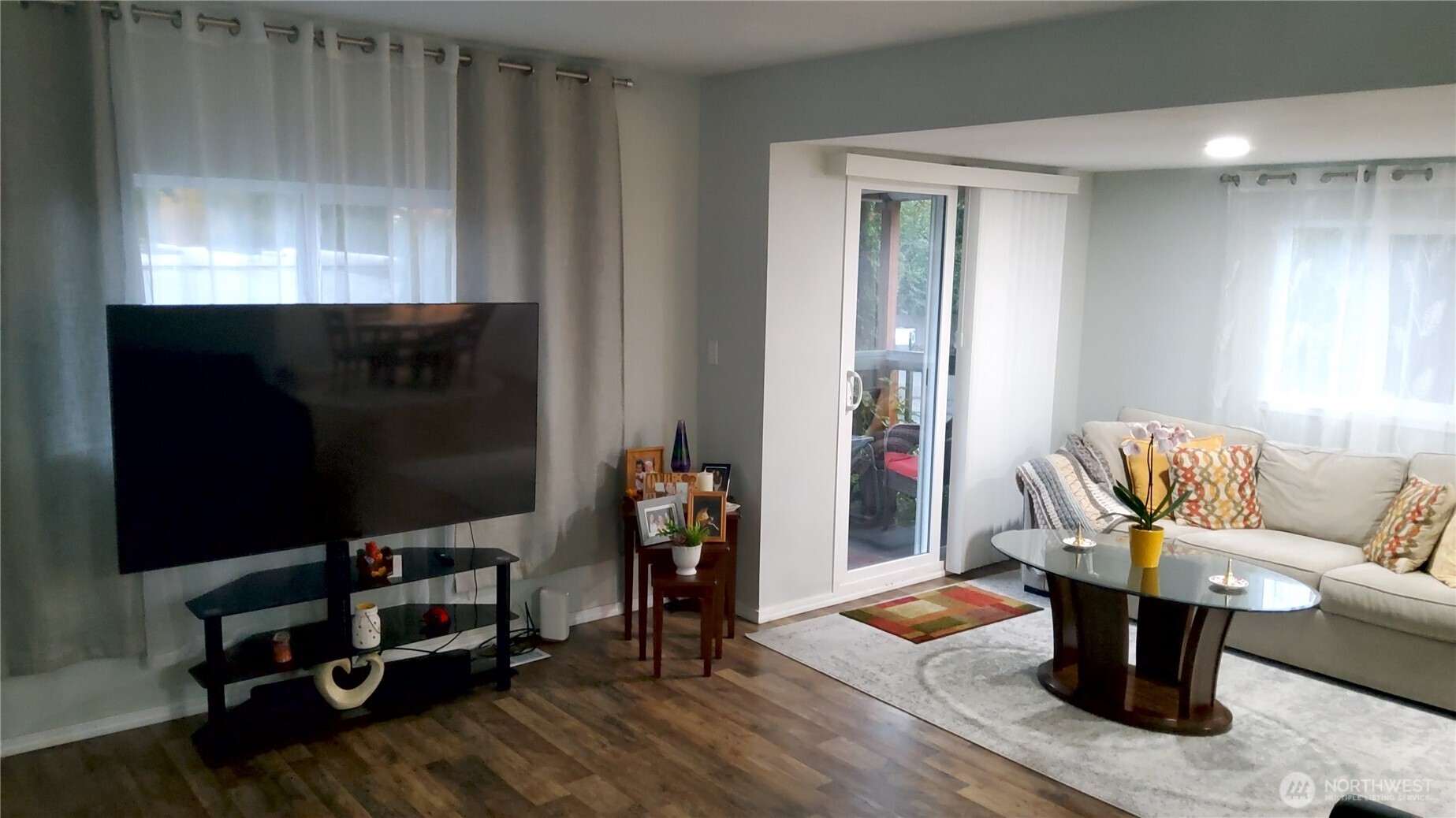 13320 Highway 99, Unit 34 Everett, WA 98204 - Photo 4 of 23 a living room with furniture a flat screen tv and gym equipment