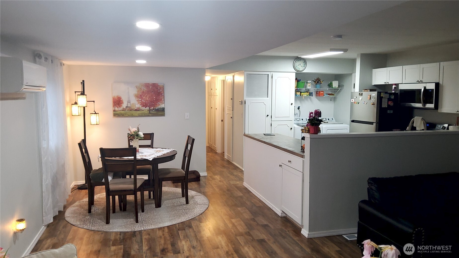 13320 Highway 99, Unit 34 Everett, WA 98204 - Photo 6 of 23 a kitchen with stainless steel appliances a dining table chairs and a refrigerator