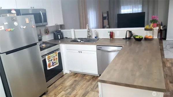 a kitchen with a sink appliances and cabinets