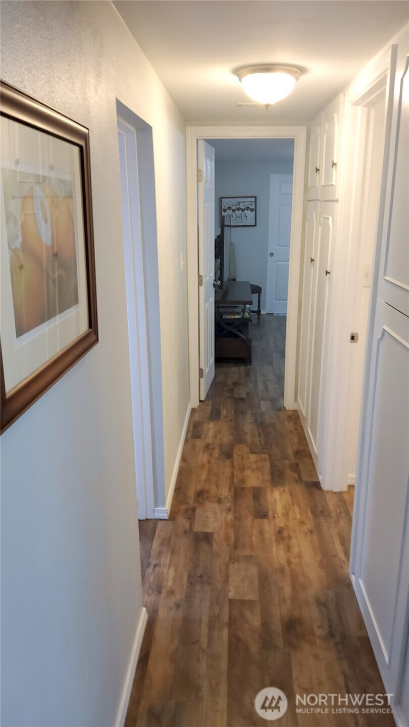 13320 Highway 99, Unit 34 Everett, WA 98204 - Photo 10 of 23 a view of a hallway with wooden floor and a bathroom