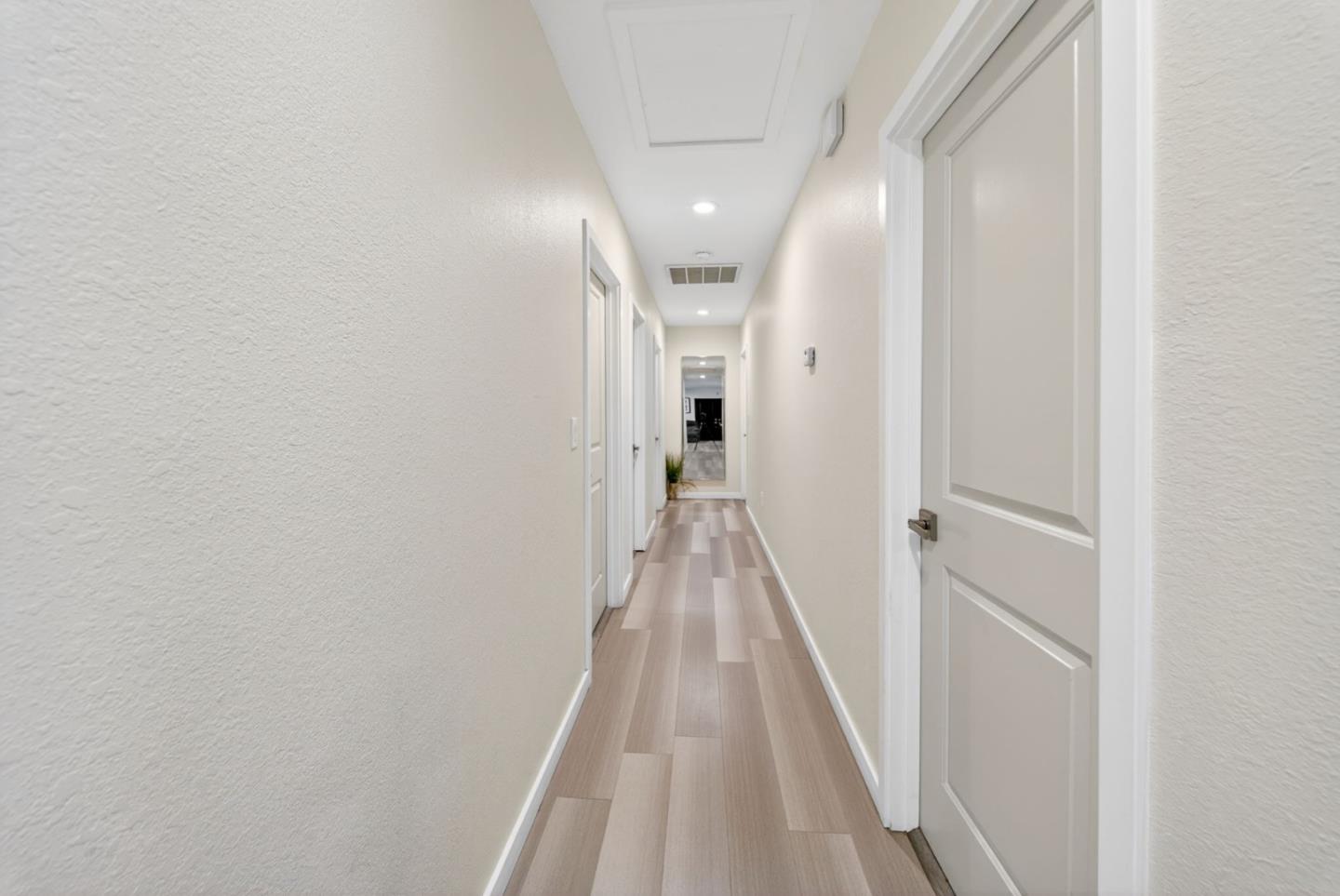 919 Old Canyon Road Fremont, CA 94536 - Photo 13 of 55 a view of a hallway with wooden floor and staircase