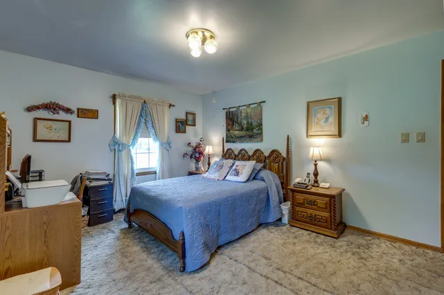 a bedroom with bed and a couch