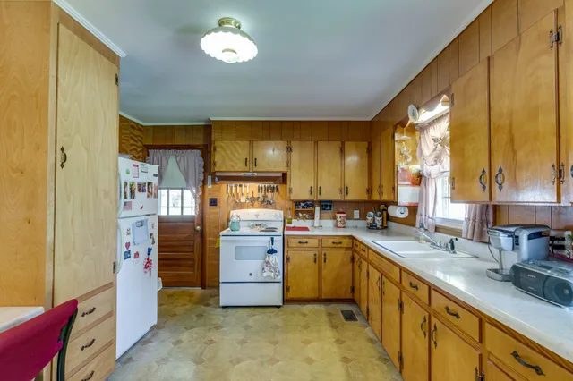 a kitchen with sink cabinets and appliances