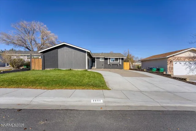a view of house with yard and garage