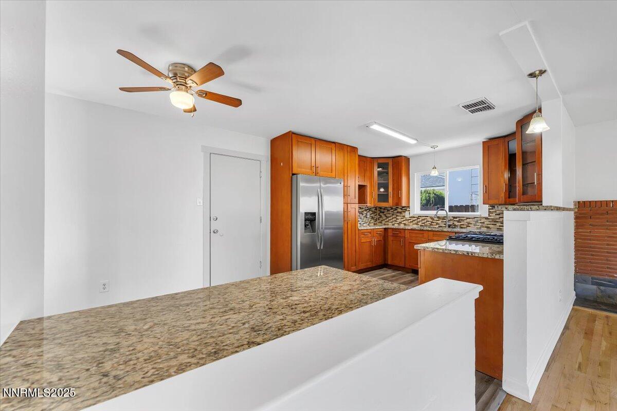 2801 Kings Row Reno, NV 89503 - Photo 9 of 32 a kitchen with stainless steel appliances granite countertop a refrigerator a oven a sink and dishwasher