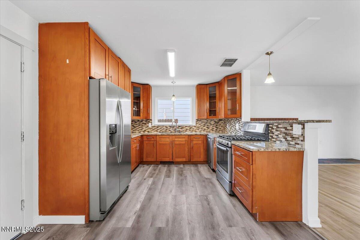 2801 Kings Row Reno, NV 89503 - Photo 10 of 32 a large kitchen with stainless steel appliances a refrigerator and a stove top oven