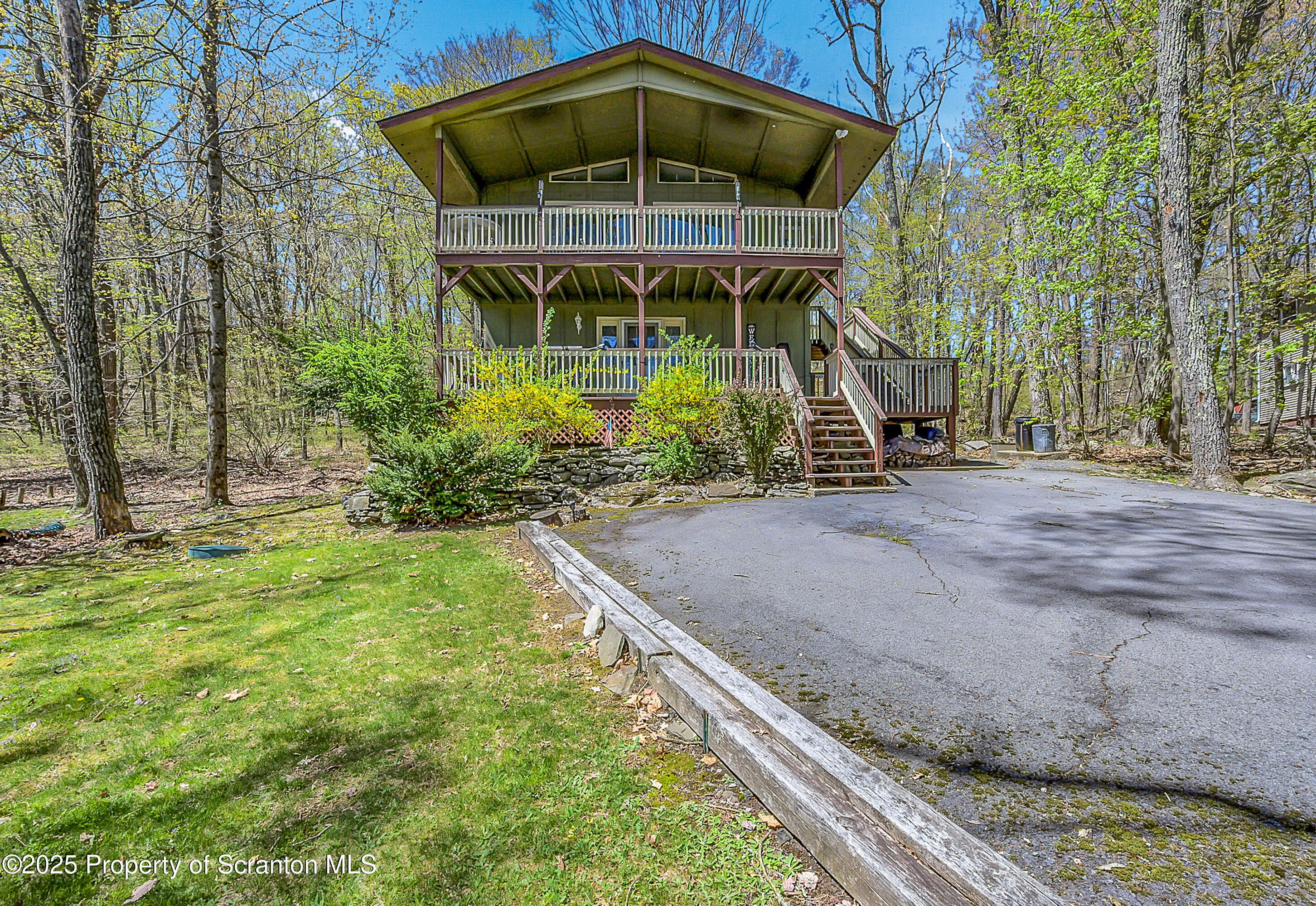 106 Lookout Drive Hawley, PA 18428 - Photo 1 of 43 a front view of a house with garden