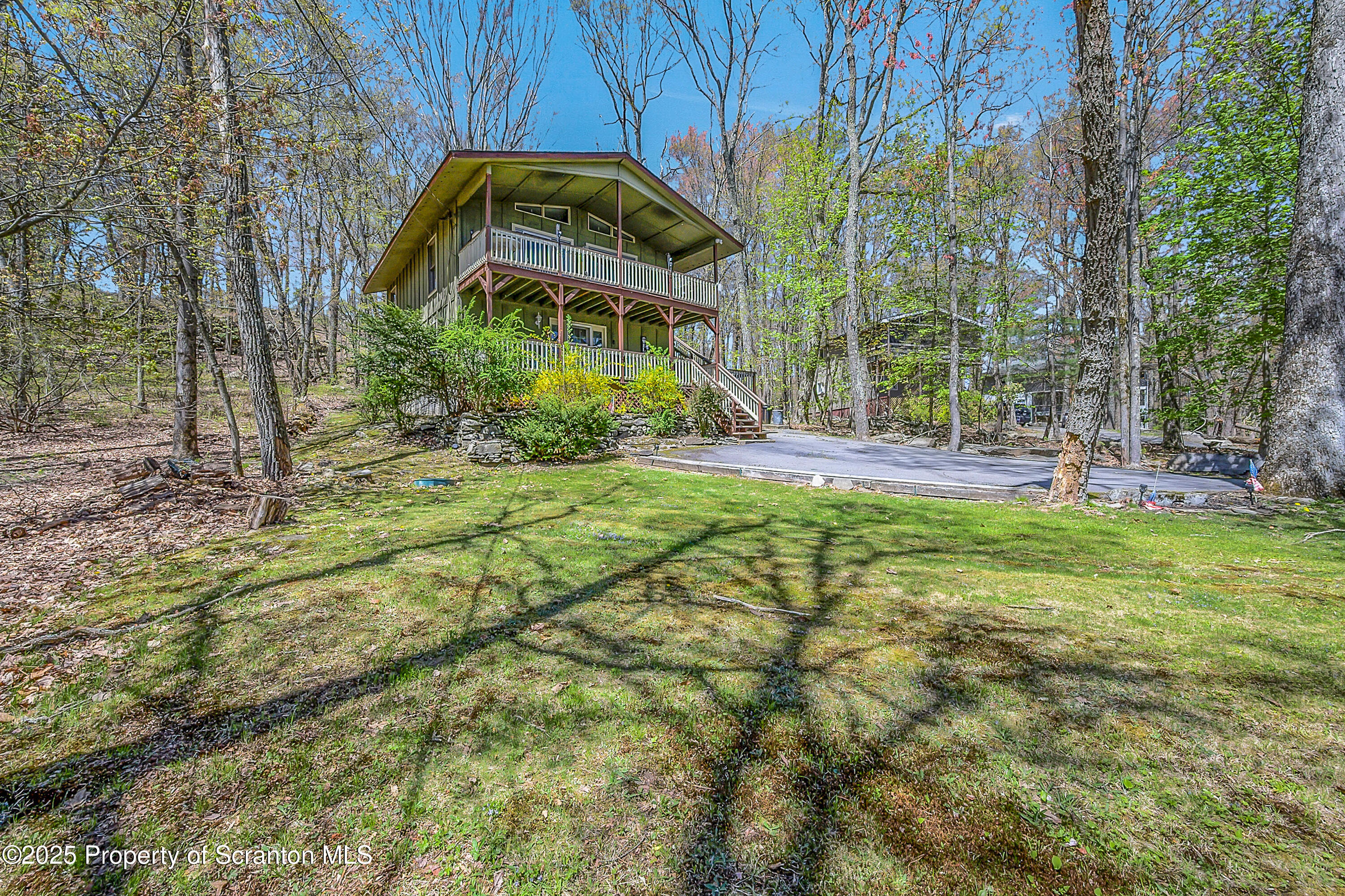 106 Lookout Drive Hawley, PA 18428 - Photo 13 of 43 a backyard of a house with table and chairs